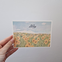 Bela art kartica sa ilustracijom polja suncokreta pod plavim nebom i natpisom On a Journey