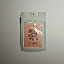 Magnet sa ilustracijom kapibare koja drži ljubičasto srce, spakovan u providnu kesicu sa holografskim ivicama.